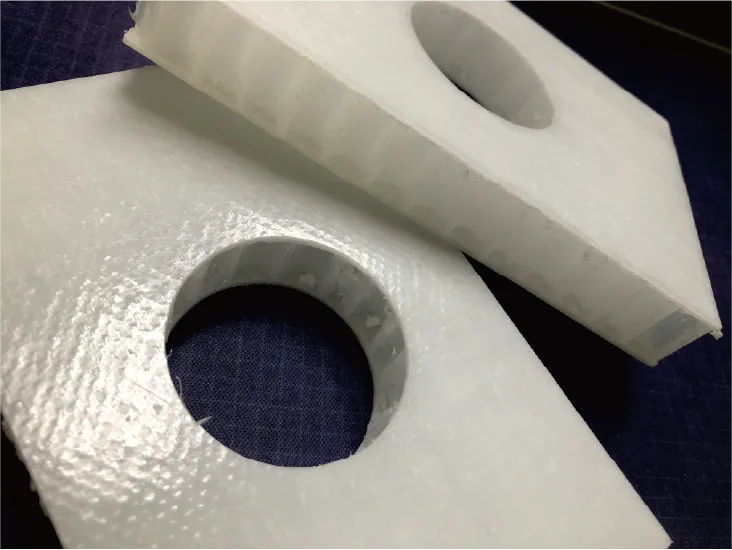 Precision-cut fiberglass honeycomb composite panels processed by ZINGCUT CNC cutting machine, showing clean cutouts and smooth edges