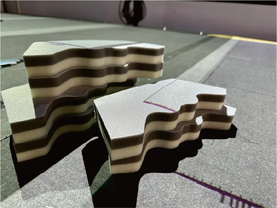Precision-cut multi-layer composite foam sponge parts processed by ZINGCUT CNC cutting machine, showing clean layered edges
