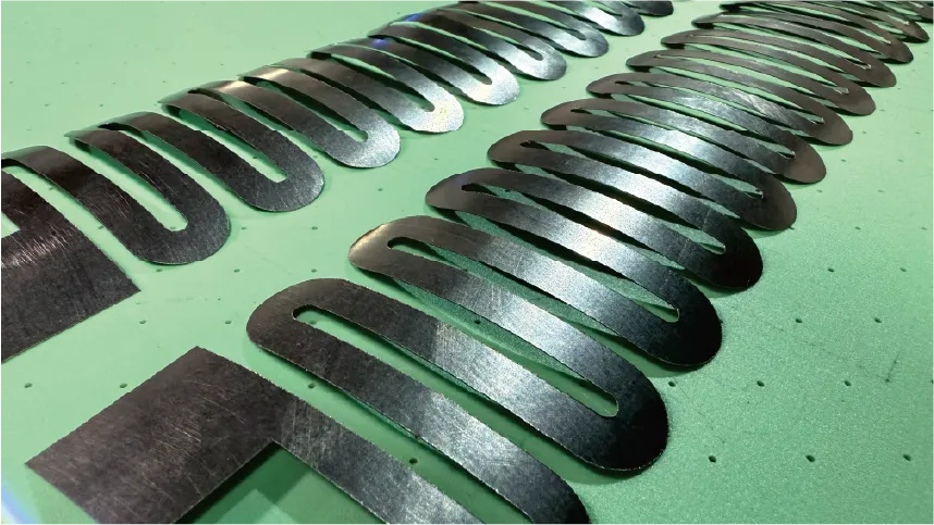 Precision-cut graphene composite parts processed by ZINGCUT CNC cutting machine, showing clean, smooth edges on custom-shaped components