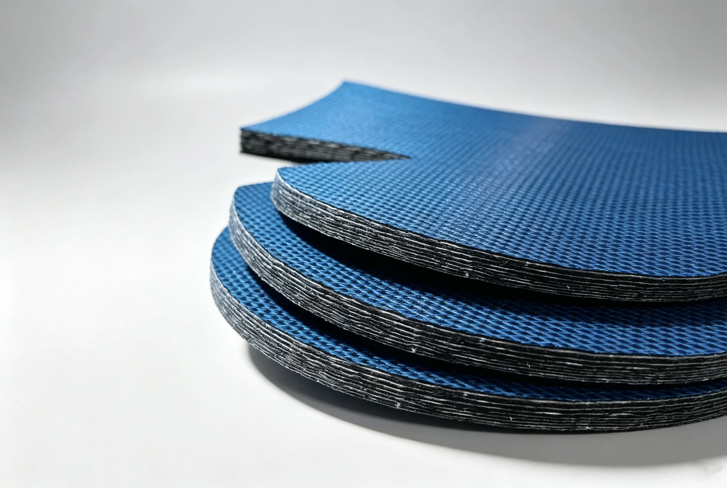 Stacked sheets of carbon fiber prepreg composite material processed by flexible digital cutter